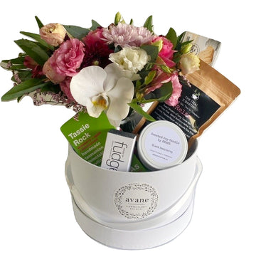 A fabulously luxe hamper with everything lovely. All Tasmanian goodies including: - A gorgeous posy of seasonal pink and white blooms in a glass vase - Black Raspberry Soy Candle - Tasmanian Devil Fudge (100g) - "Relax" Tasmanian Tea - Cripps Shortbread - Tassie Rocks Candy This gorgeous gift is packaged in a lovely hamper box, wrapped and ribboned and hand delivered with a custom card message. How wonderful it is to know that in this hectic world, your recipient will be able to relax and indulge